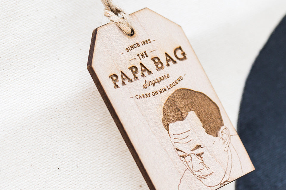 Each bag is paired with a thick wooden tag engraved with a specific quote from Minister Mentor Lee Kuan Yew reflective of his portrait drawn.