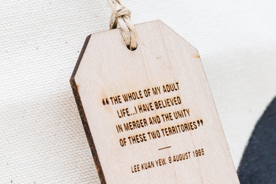 Each bag is paired with a thick wooden tag engraved with a specific quote from Minister Mentor Lee Kuan Yew reflective of his portrait drawn.