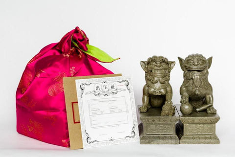 The GOODSTUPH Stone Lions snuggle up in a cost oriental wrap and a birth certificate for the rightful owner.